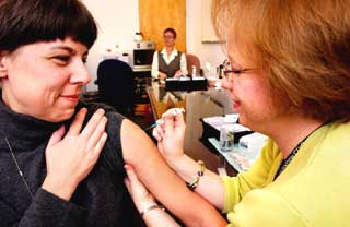 Health - Picture woman getting flu shot